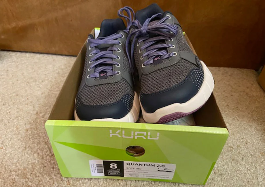 A pair of new KURU QUANTUM 2.0 shoes spills out of a freshly-opened shoebox.