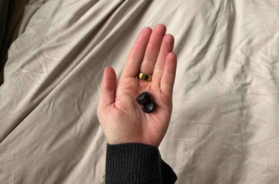 A person holds some Olly Sleep Gummies in their hand.