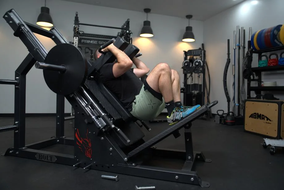 Coop squats on the Bolt Fitness Hack Squat Leg Press machine.