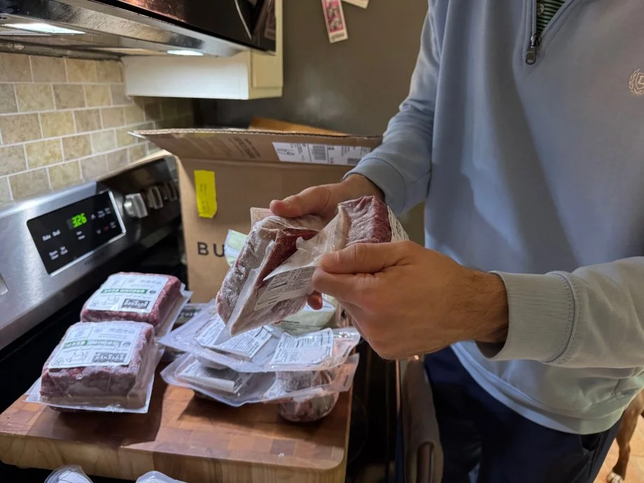 A person opens a package of ground beef from ButcherBox.