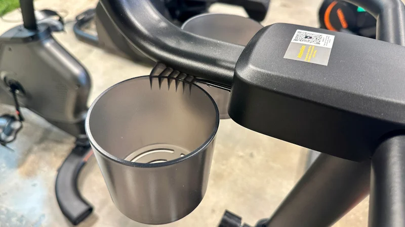 A close look at the cupholder on a Merach 36S Magnetic Exercise Bike