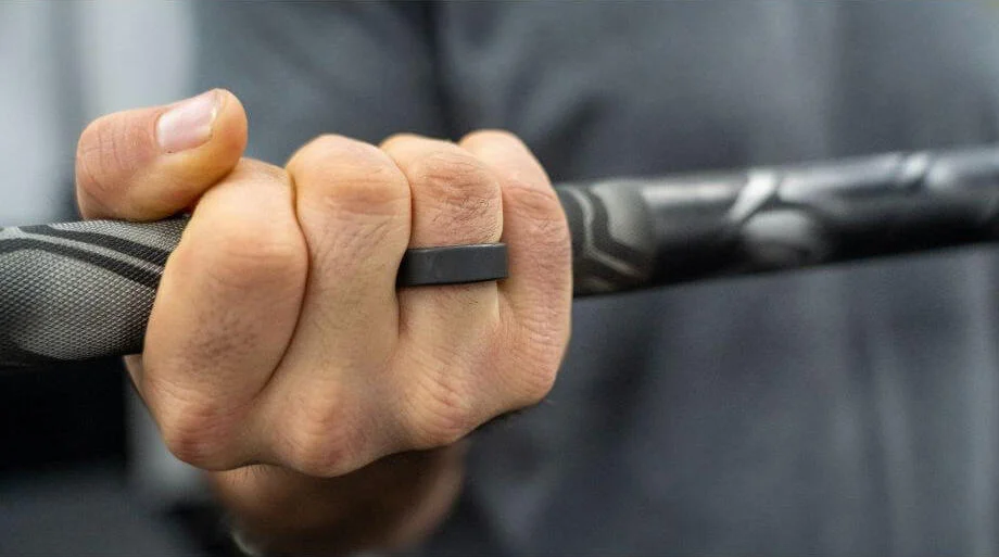 A close look at the Oura Ring on Coop's hand while he's holding a barbell