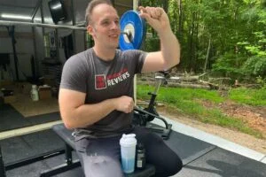 gnc amp creatine man holding pill