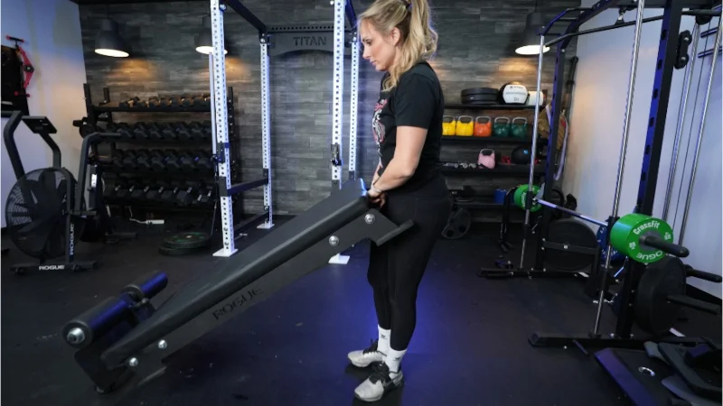 Our tester moving the Rogue Floor Glute machine