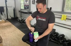 kos greens man scooping into cup