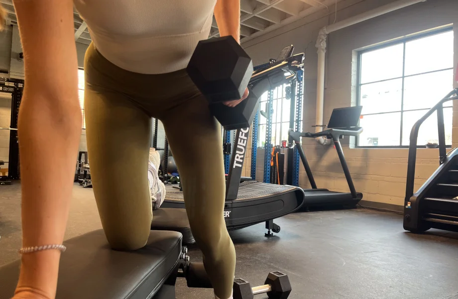 A person performing dumbbell rows with Iron Bull Rubber Hex Dumbbells.