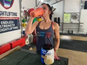 person drinking pure protein powder