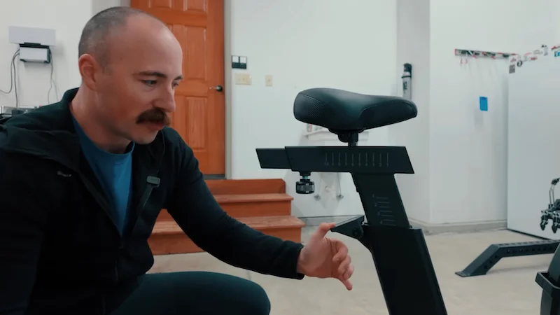 Coop adjusting the seat on the REP Strive Air Bike