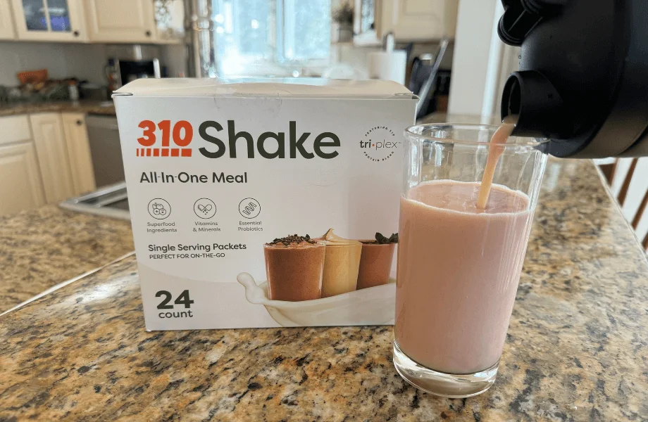 Our tester preparing a 310 All-in-One Meal Replacement Shake serving in a kitchen glass