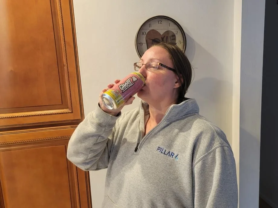 A woman drinking a can of Ghost Energy