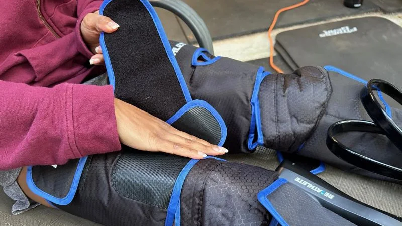 Our tester straps into a pair of ReAthlete Air-C Leg Massager compression boots