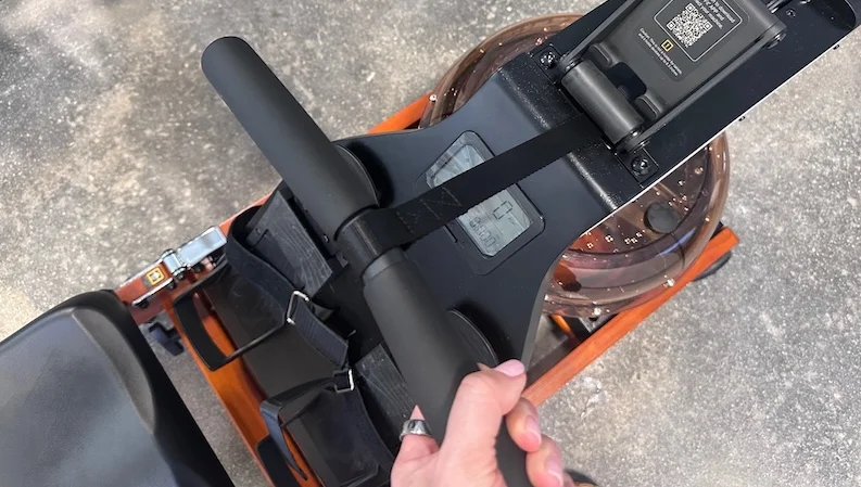 Product tester holding the handle on the WalkingPad KingSmith WR1 Foldable Water Rowing Machine