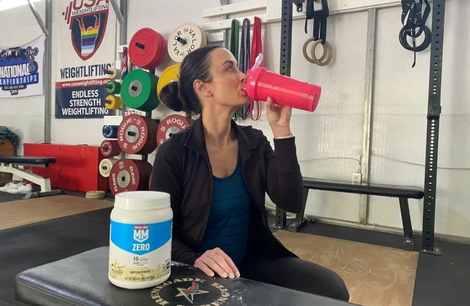 A person drinking Muscle Milk Zero