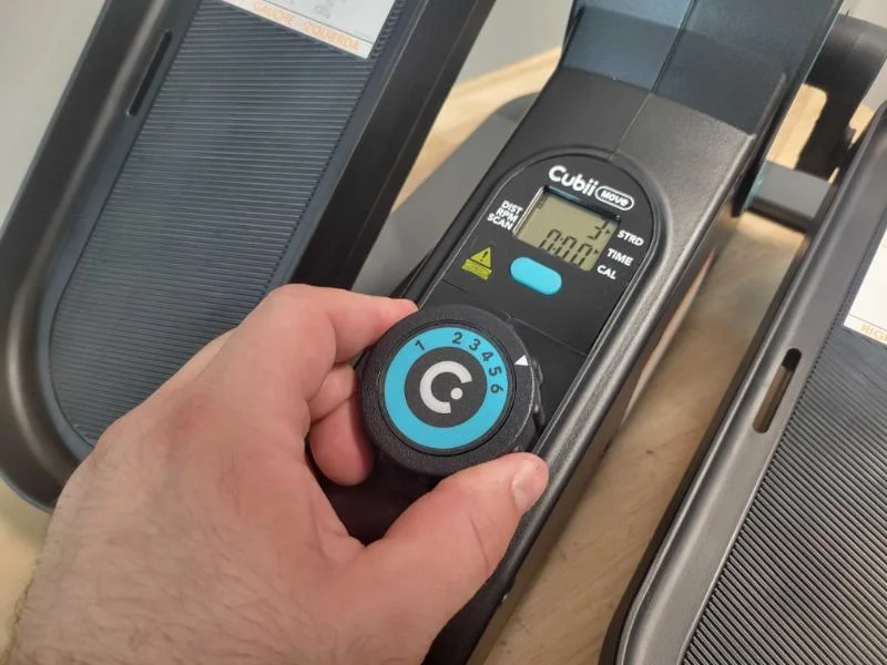 Our product tester makes an adjustment to the Cubii Move's resistance