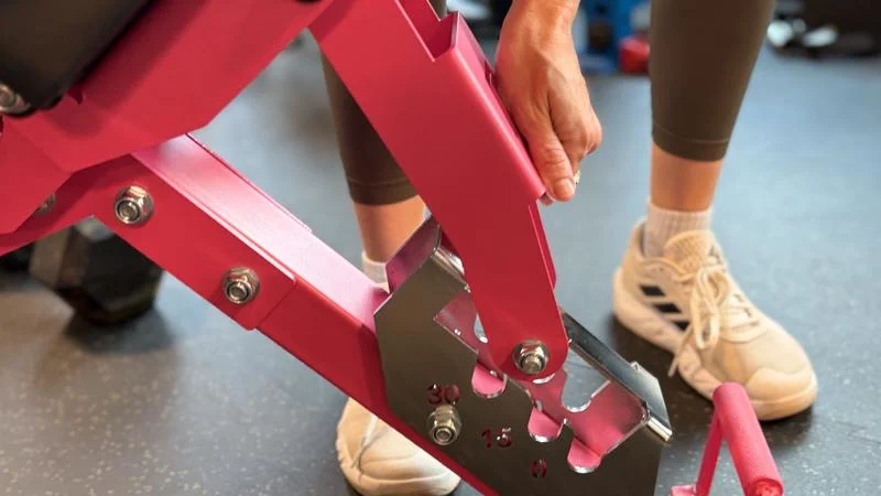 A person adjusts the backrest on the Ritfit Gator Bench.