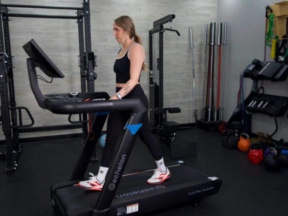 woman walking on echelon stride 8s treadmill view from side