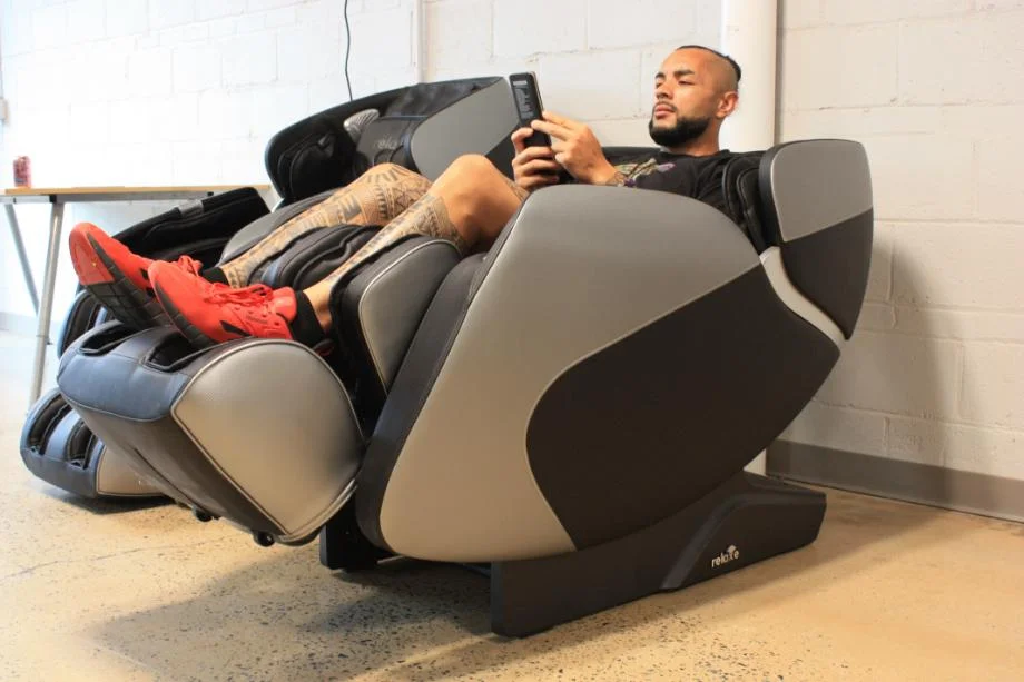 Stephen Sheehan, CPT, CNC reclines in a Relaxe Zero-Gravity Shiatsu Massage Chair.