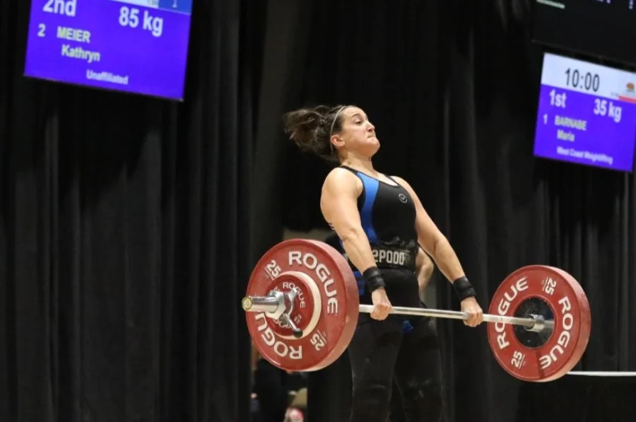 Kate performing a clean and jerk with 85 kg at a weightlifting competition