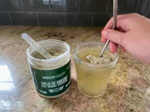 field of greens stirring in glass