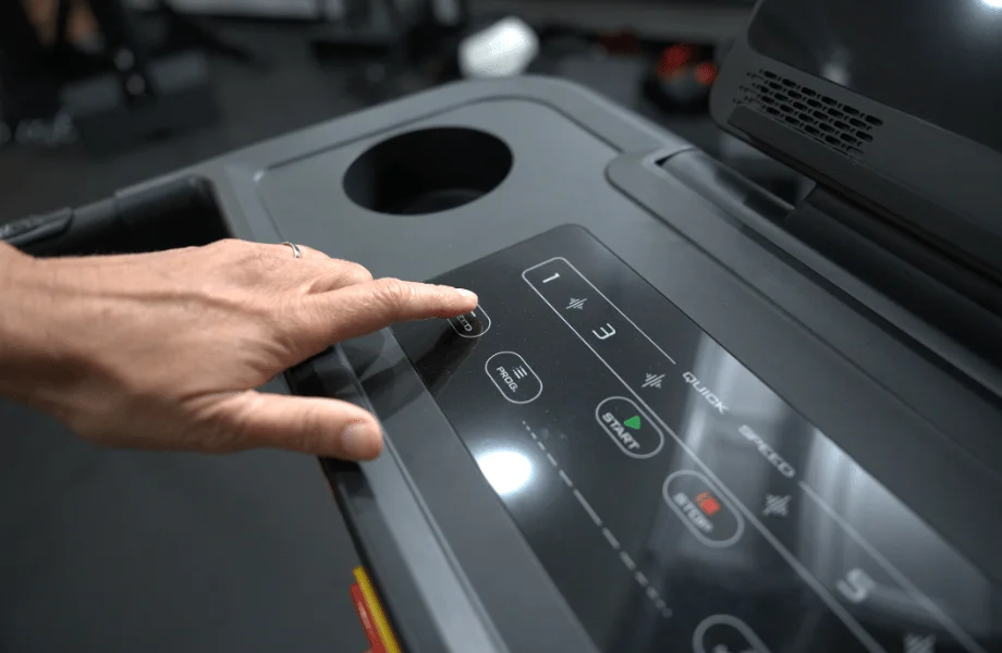 Our tester making speed adjustments on the MERACH T12 Foldable Walking Treadmill's center console