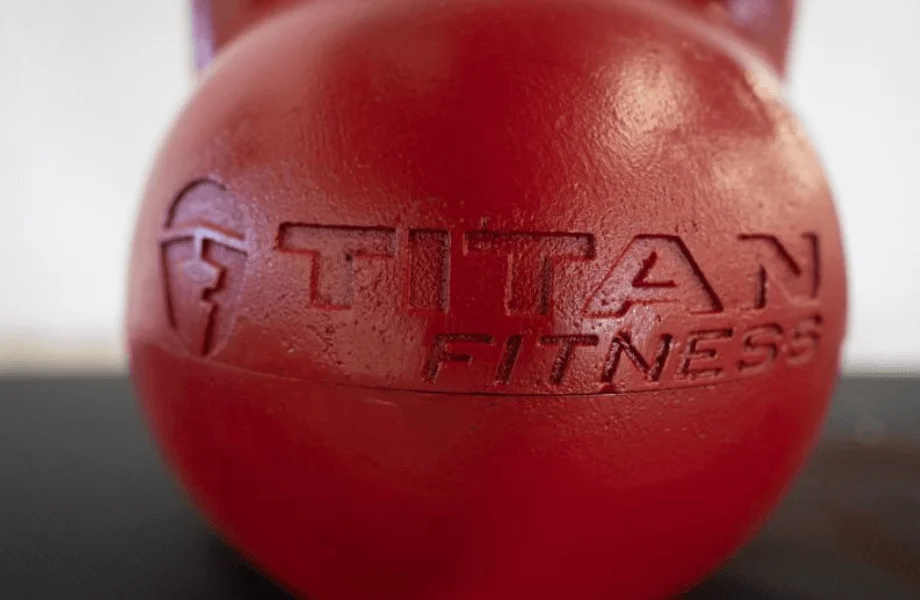 The front logo and exterior shell of the Titan Fitness Adjustable Competition-Style Kettlebell
