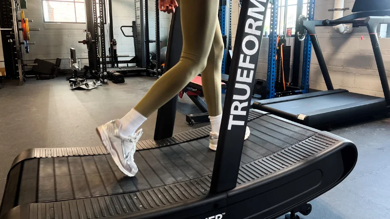 Our tester walking on the TrueForm Trainer manual treadmill