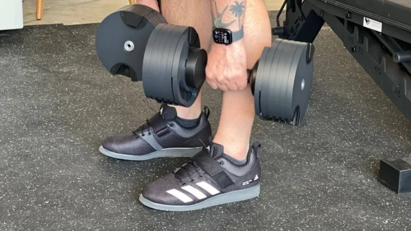 A person lifting In Adidas Powerlift shoes