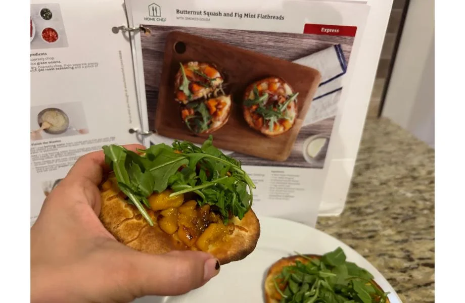 Person having prepared mini flatbreads with dates from Home Chef