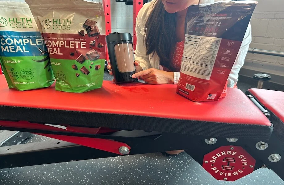 Our tester mixing up a serving of HLTH Code Complete Meal in their handheld blender