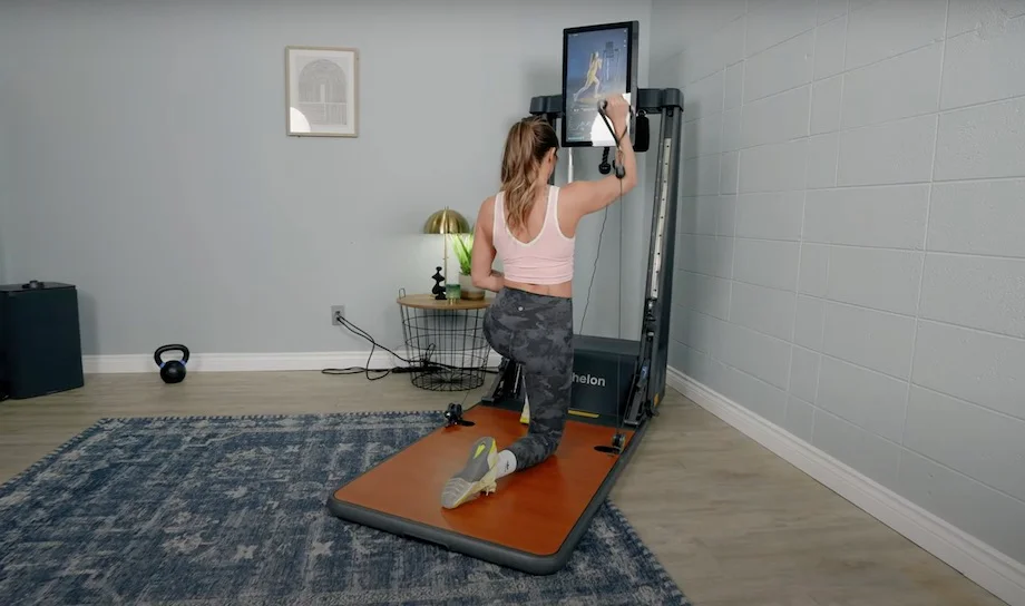 Lindsay Scheele kneels during a workout on the Echelon Strength Home.