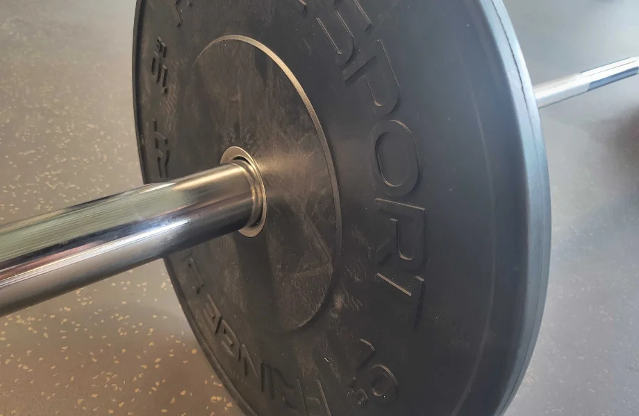 A 10-pound Fringe Sport Black Bumper Plate loaded onto a barbell