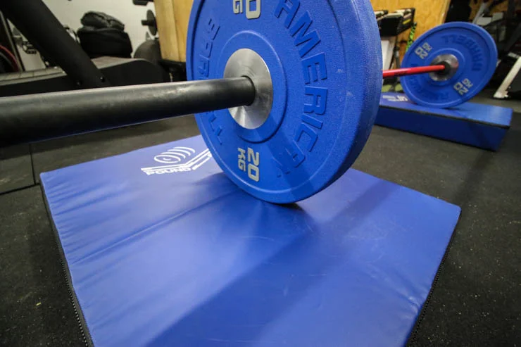 Pound Pad under barbell in a garage gym