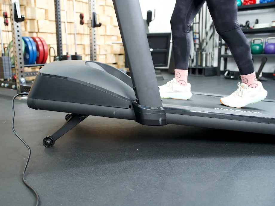 GGR product tester walking on the Aviron Victory treadmill on a slight incline