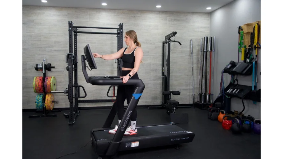 Woman standing on Echelon Stride 8s choosing programming