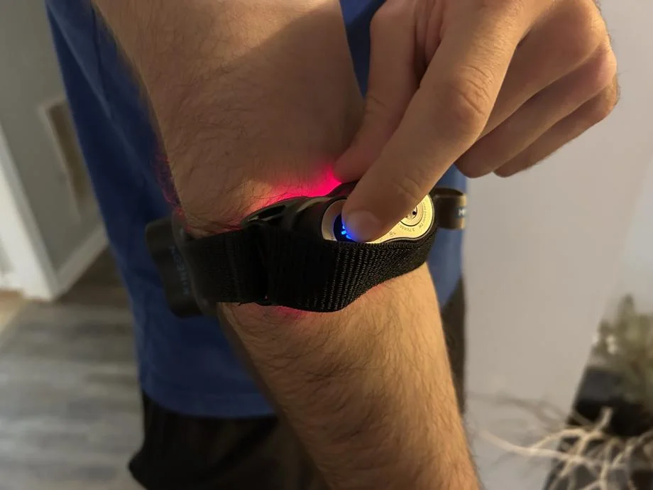 Our tester using the Kineon The Move+ Pro on their elbow