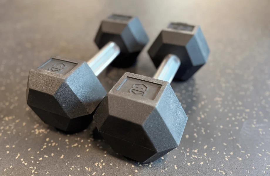 A pair of Iron Bull Rubber Hex Dumbbells on the GGR testing center floor