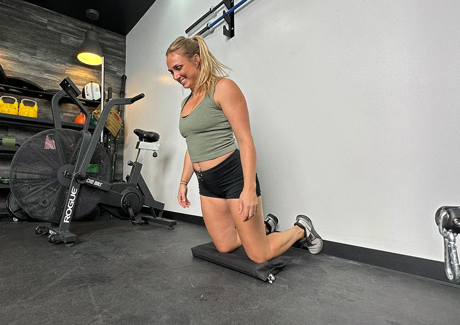 woman-doing-wall-hamstring-curl-exercise