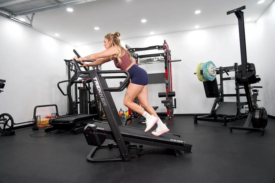 Lindsay Scheele, CPT does a sled push on the Xebex Trekker 4000 treadmill.
