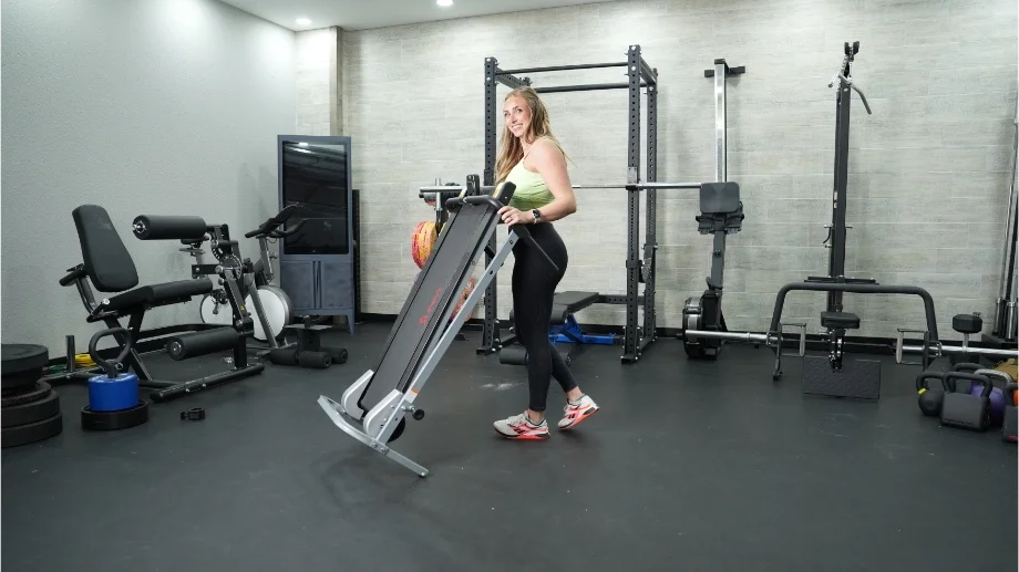 sunny health and fitness manual treadmill moving treadmill smiling at camera copy