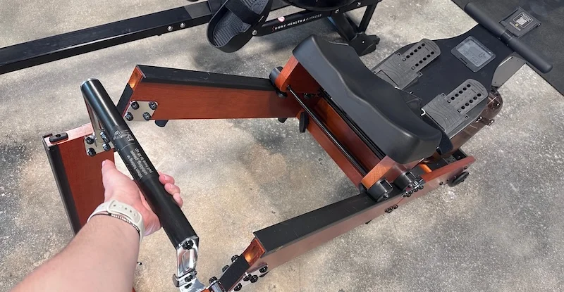 Product tester using the folding mechanism on the WalkingPad KingSmith WR1 Foldable Water Rowing Machine
