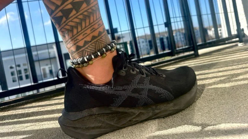 Our tester wearing a pair of ASICS Novablast 5 running shoes