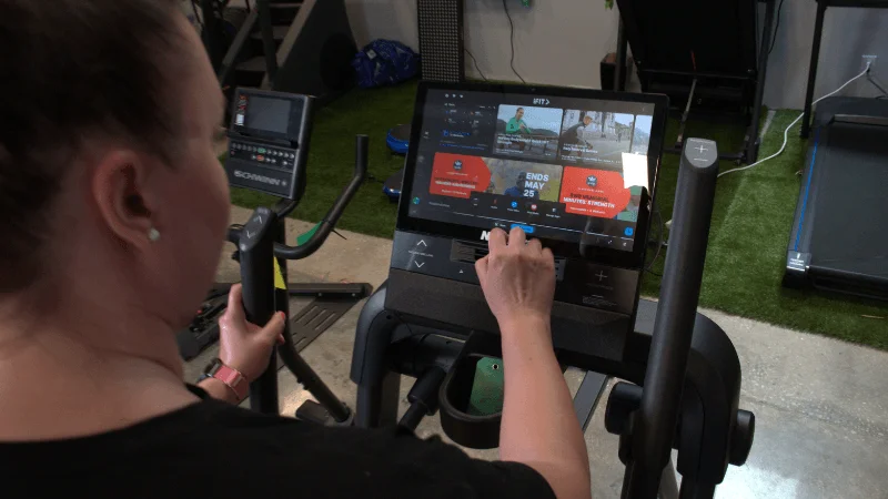 Our tester selecting an iFIT workout on the NordicTrack X16 elliptical