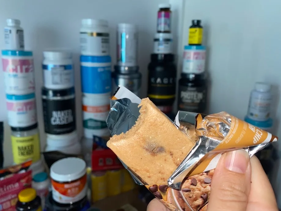 A person holds a Quest Nutrition Protein Bar