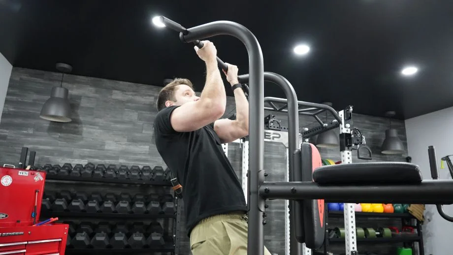 Man doing chin-ups on the weider power tower