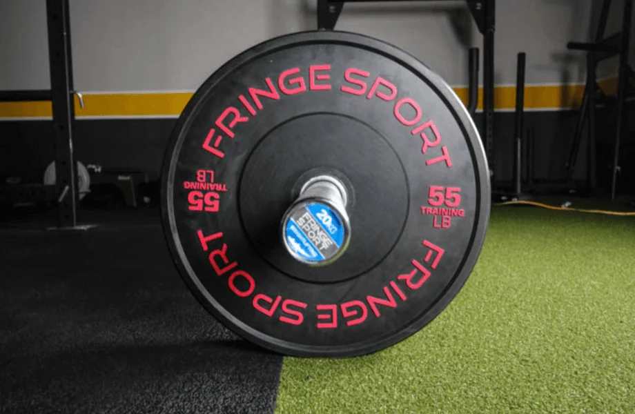 Fringe Sport Black Bumper Plate on barbell, side view