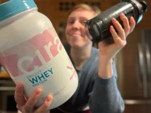 Cira Whey Woman Holding Shaker Cup