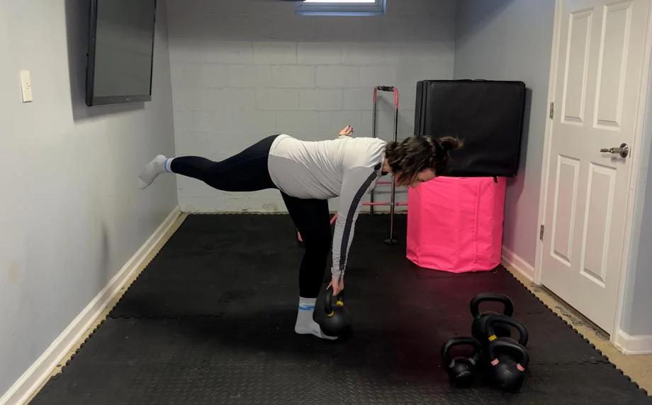 Our tester Nicole Davis, CPT, PN1-NC, working out with a Kettlebell Kings Kettlebell.