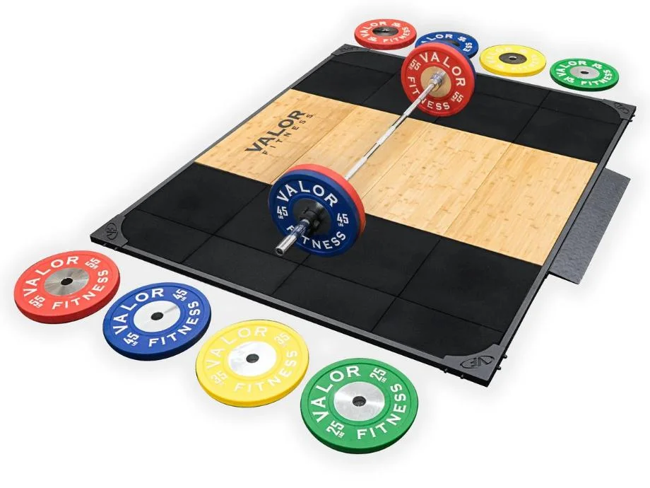 A Valor Fitness Olympic Platform with a barbell and some weight plates staged around.