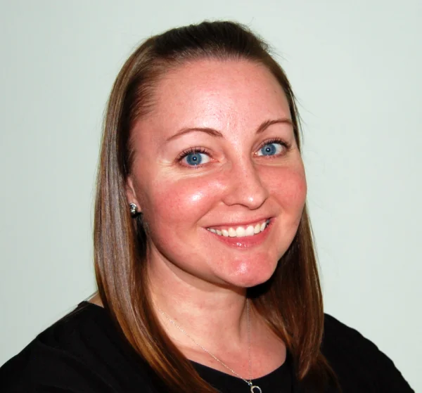 An adult woman smiling at the camera