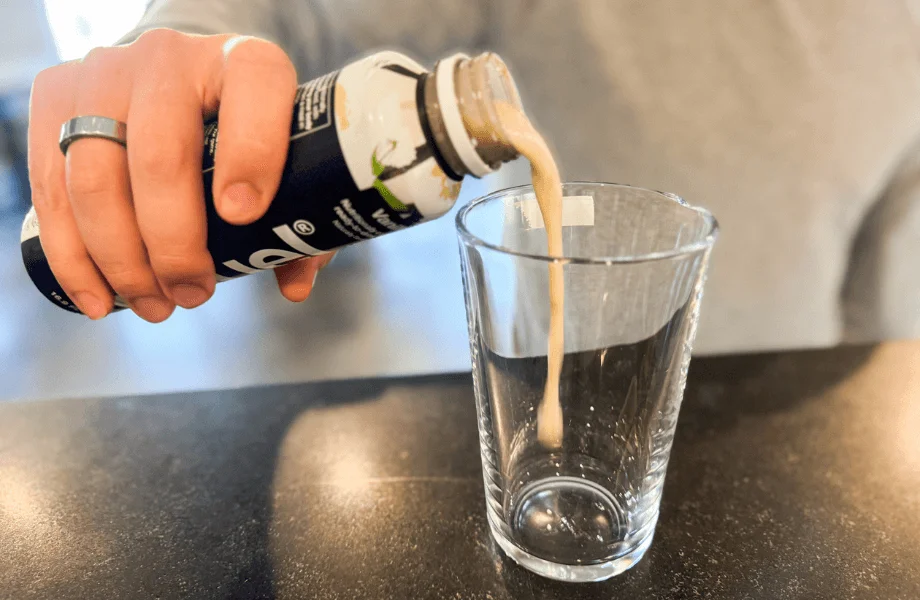 Our tester pouring Huel Ready-to-Drink into a pint glass